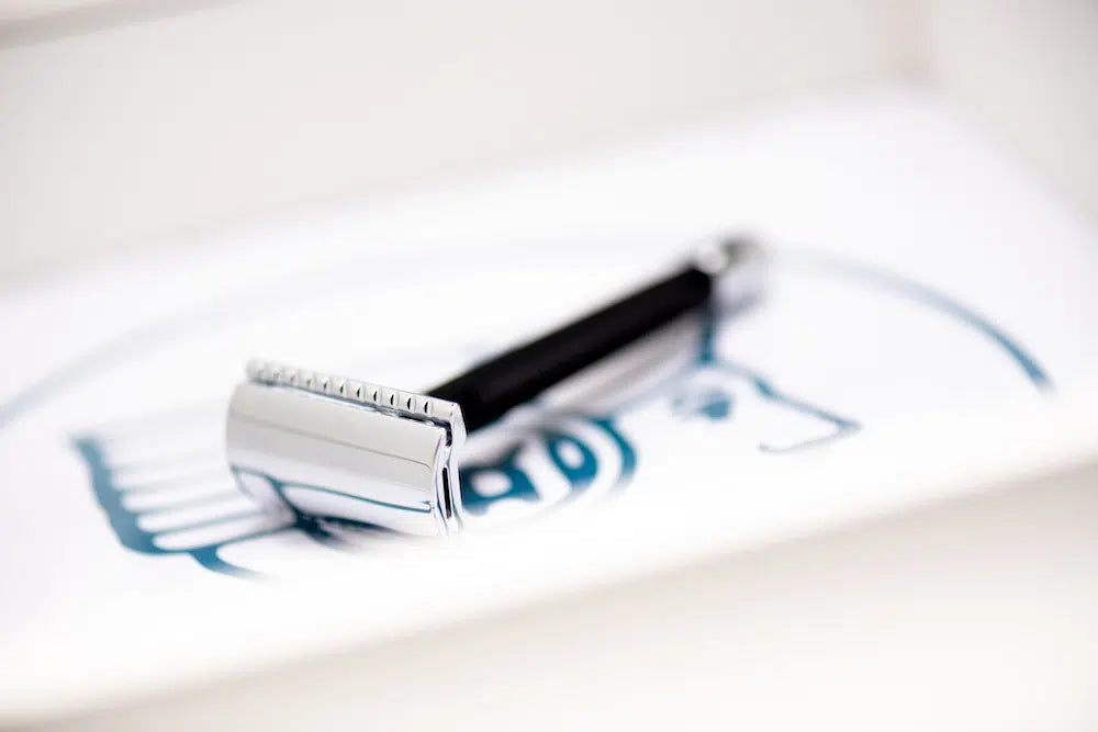 Safety razor on branded background